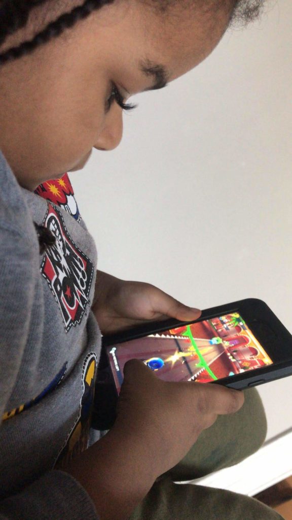 Subject playing the mobile app game "Grom Skate" on an iPhone.