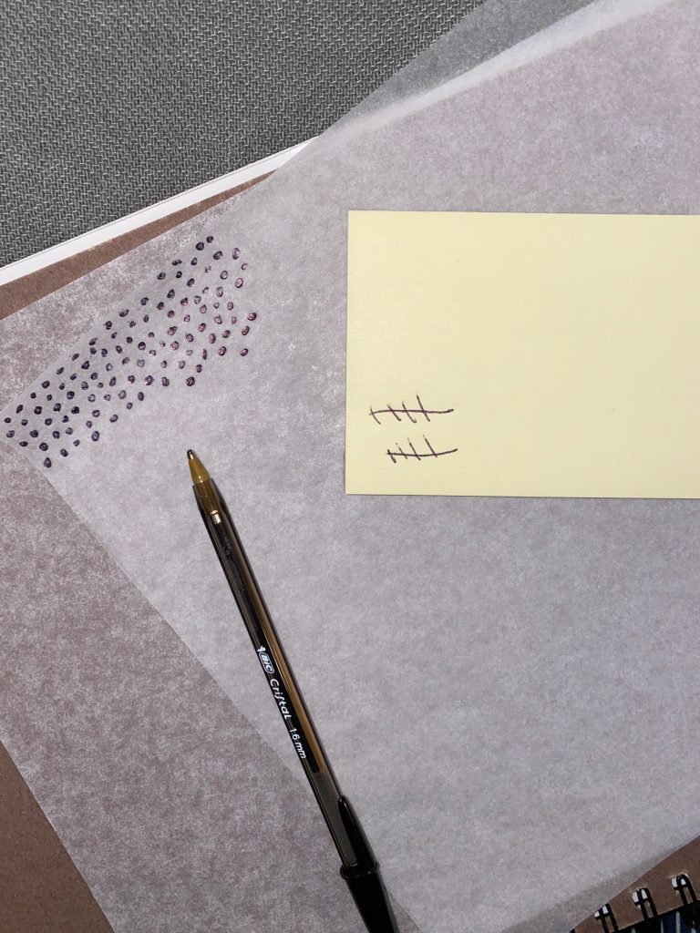 image of tracing paper partially marked with dots created with a ball point in frame.