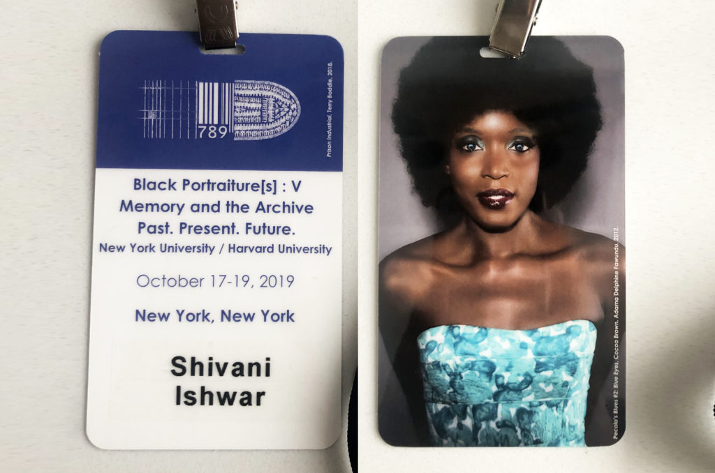 Identification badge with event information and logo on one side and a photograph of a black woman taken by Adama Delphine Fawundu on the other side.