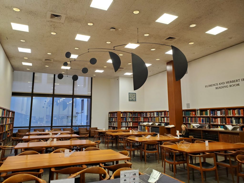 The reading room at the Thomas J. Watson Library with an Alexander Calder mobile hanging from the ceiling.